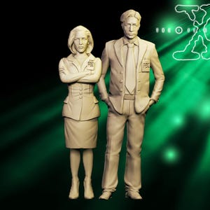 May include: A pair of beige figurines of a man and woman in suits, with "FBI" badges. The woman has her arms crossed. The man has his hands in his pockets. The background is dark with a green glow and the X-Files logo.