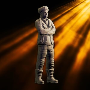 May include: A gray figurine of a person in a jacket, pants, and boots, with arms crossed. The figure wears a hat and has a scarf around the neck. The background is dark with a golden light shining from the right.