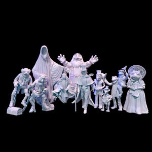 May include: A collection of white figurines depicting various characters, including a ghost, a Santa Claus-like figure, and several anthropomorphic animals. The figures are arranged against a black background, creating a dramatic contrast.