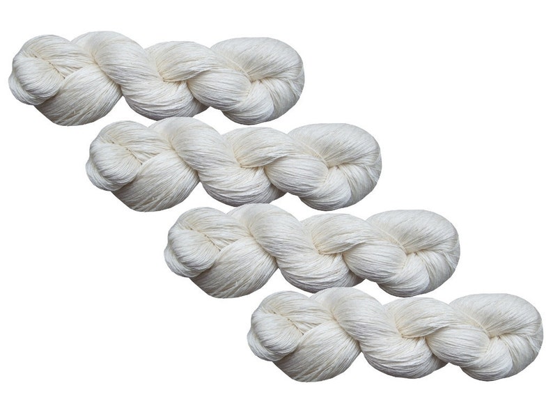 May include: Four skeins of white yarn, each twisted into a rope-like shape.