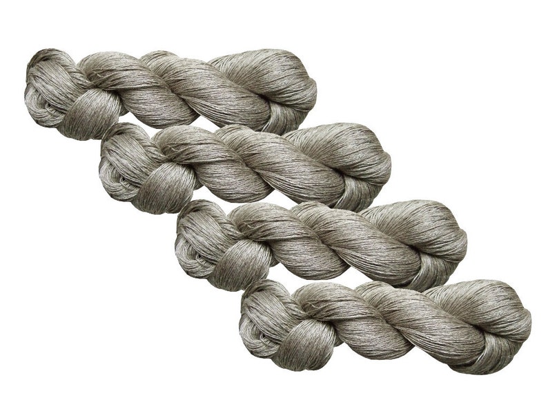 May include: Four skeins of light gray linen yarn, twisted and piled on top of each other.