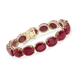 May include: A gold bracelet with oval rubies. The rubies are a rich red hue, set in individual gold bezels. The bracelet has a secure clasp. The design is suitable for daily use.