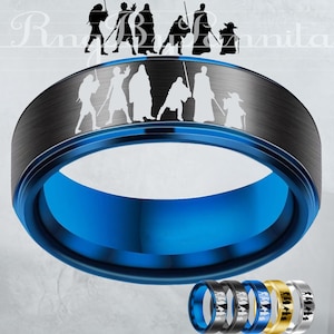 May include: A blue and black ring with a brushed metal finish. The ring features a blue interior and a band with white silhouettes of characters. Several rings in different colors are displayed below the main ring.