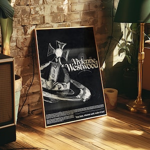 May include: A framed black poster with a gold border, featuring the Vivienne Westwood logo and a hat and planet illustration. The poster is propped against a brick wall. The text "buy less, choose well, make it last" is at the bottom.