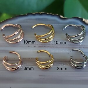 May include: Six seamless hoop earrings in three different sizes and colors: gold, rose gold, and silver. The earrings are 8mm and 10mm in diameter.