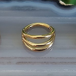 May include: Gold double hoop septum ring with a seamless design. The ring is made of surgical steel and is available in a variety of sizes.