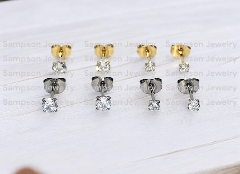 May include: Six pairs of earrings with a single clear stone on each earring. Three pairs have gold posts and three pairs have silver posts.