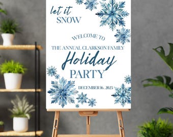May include: A white sign on a wooden easel with the text "Let it Snow" and "Welcome to the Annual Clarkson Family Holiday Party". The sign is decorated with blue watercolor snowflakes and the date December 16, 2025.
