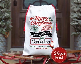 May include: White Christmas gift bag with red drawstring and accents. The bag features the text "Merry Christmas," "Nice List Approved," and "Special Delivery for Samantha." A Santa Claus illustration is also present.