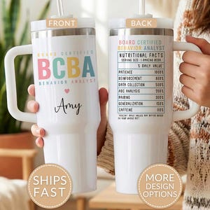 May include: A white insulated tumbler with a handle, featuring the text "BOARD CERTIFIED BCBA BEHAVIOR ANALYST" in colorful letters. The front includes a name and a heart. The back displays a "Nutritional Facts" chart.