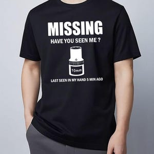 May include: A white ceramic mug with a black handle and the text "But First, Coffee" in a handwritten style. The mug is on a white surface. The mug is approximately 4 inches tall.