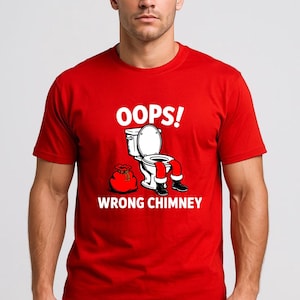 May include: Red t-shirt with the text "OOPS! WRONG CHIMNEY" and a humorous graphic of Santa Claus stuck in a toilet. The graphic features Santa's legs and a sack of gifts. The shirt is short-sleeved.
