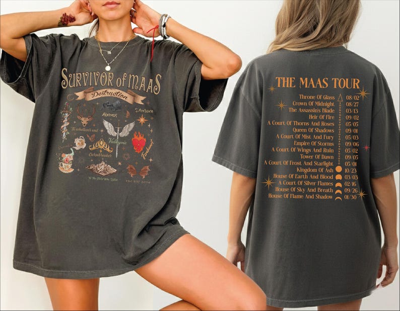 A person wearing a black t-shirt with a graphic design and text, posing with their hands on their head.