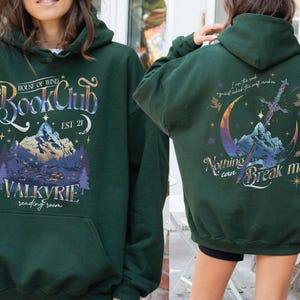 two green hooded sweatshirts with various designs and text on them.
