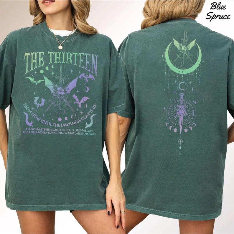 A woman wearing a green t-shirt with a graphic design on the front and back.