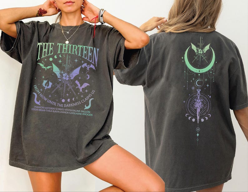 A person wearing a black t-shirt with a graphic design on the front and back.