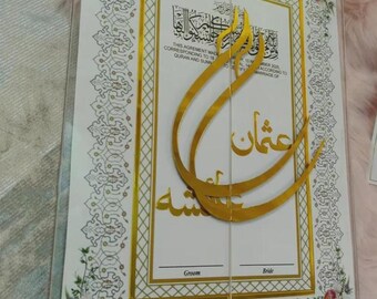 May include: A wedding certificate in a clear acrylic frame. The document has gold accents and floral decorations. The text includes Arabic script and English text, with spaces for the groom and bride's names.