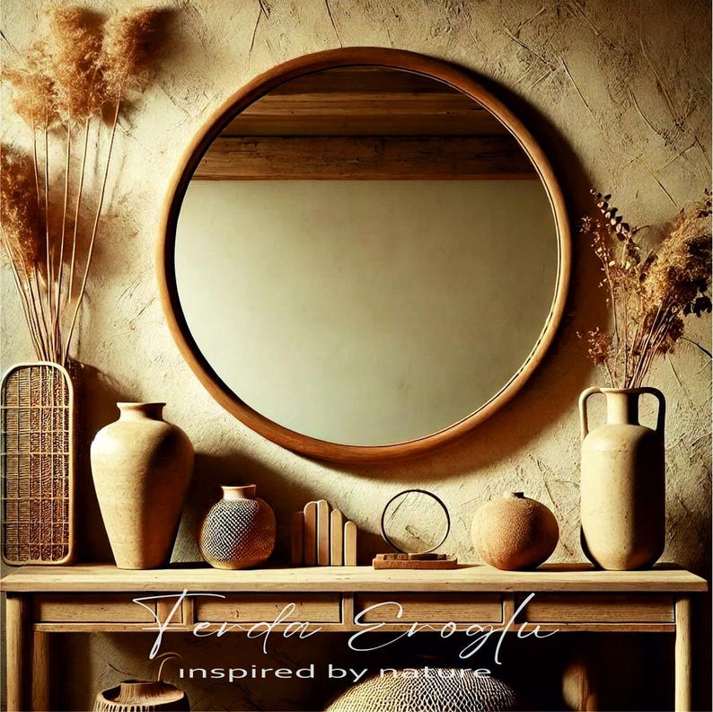 Round oak wood mirror in a rustic interior with warm earthy tones, surrounded by ceramic vases and natural fiber decor pieces.