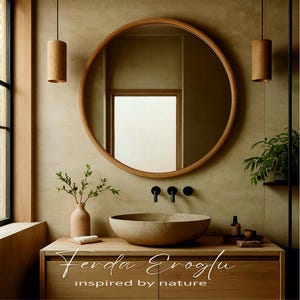 A round oak framed mirror in a modern bathroom with neutral tones, paired with a stone sink and natural accessories for a calm, minimalist look.