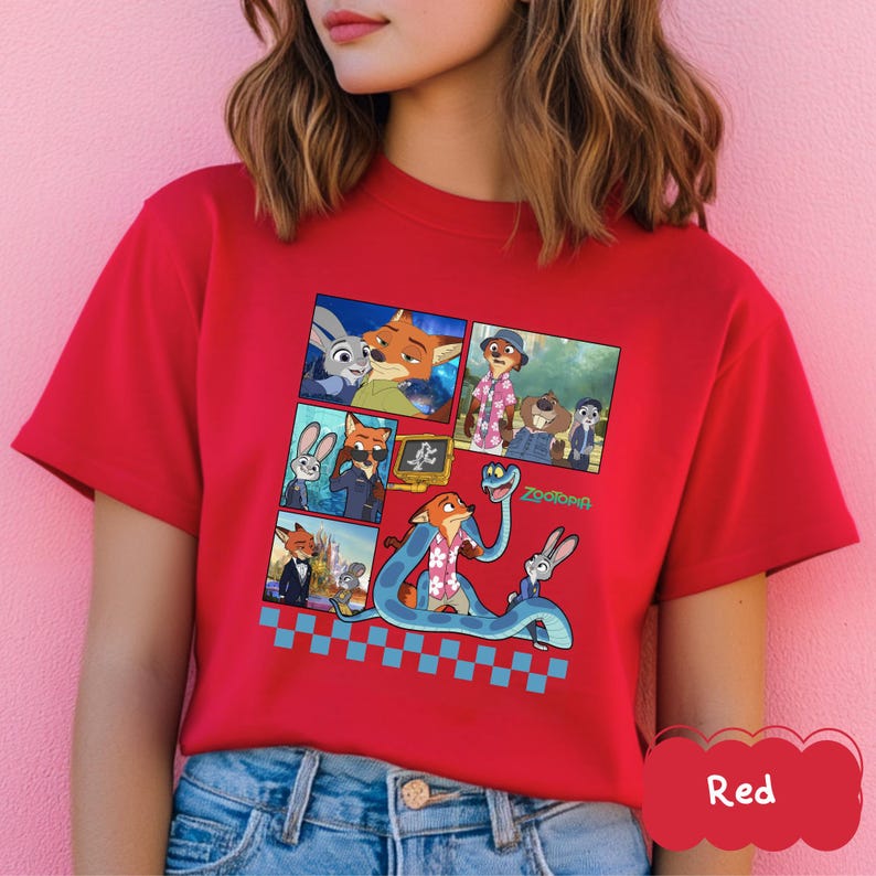 May include: Red t-shirt featuring a colorful graphic of characters from the animated movie Zootopia. The design includes images of a fox, a bunny, and other characters in a comic strip style, with a blue and white checkered pattern.