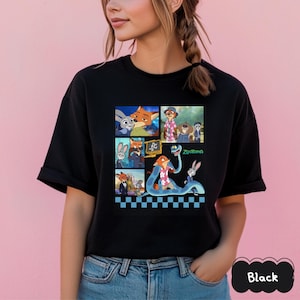 May include: Black t-shirt featuring a colorful collage of characters from the animated movie Zootopia. The design includes images of a fox, a bunny, and other characters. The word "Zootopia" is also visible.