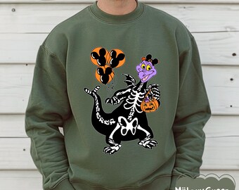 May include: A military green sweatshirt with a Halloween dragon design. The black dragon has a white skeleton overlay, holding a pumpkin and Mickey Mouse-shaped balloons. The design includes a purple dragon head and the text "Miitary Green".