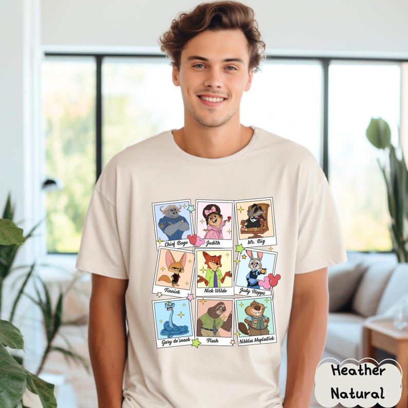 Peut inclure: Un t-shirt naturel chin&eacute; avec un graphisme color&eacute; de personnages de film. Le graphisme comprend des images de Chief Bogo, Judith, Mr. Big, Finnick, Nick Wilde, Judy Hopps, Gary de'snack, Flash et Nibbles Maplestick.
