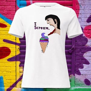 May include: White t-shirt featuring a cartoon design. The design includes the text "I Scream." above a colorful ice cream cone and a person with an open mouth and long tongue. The ice cream has purple, green, and brown layers.