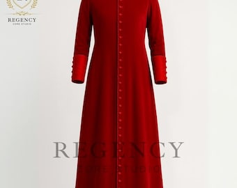 May include: A long, red velvet coat with a mandarin collar and long sleeves. The coat features a row of buttons down the front and decorative cuffs. The Regency Core Studio logo is visible in the upper left corner.