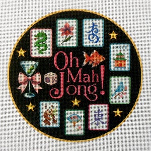 May include: A round, black canvas with a gold border features the words "Oh Mah Jong!" in pink script. The design includes various Mahjong tiles, a martini glass, a goldfish, and stars. The tiles depict a dragon, panda, and other symbols.