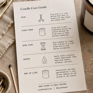 May include: A white rectangular candle care guide card with black text and line icons, featuring instructions for trimming, first burn, burn time, safety, and end of life. Includes a gold wick trimmer, a jar candle labeled Santal, and matches.