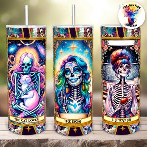 May include: Three colorful 20 oz. stainless steel tumblers with lids and straws. Each tumbler features a Day of the Dead-inspired design with a skeleton figure. One tumbler says "The Cat Lover", another says "The IDGAF", and the last says "The Teacher".