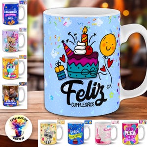 May include: White ceramic mug with a birthday cake design, a lit candle, and the words "Feliz Cumpleaños" in black script. The mug is light blue with a white handle and is surrounded by other mugs with various designs.