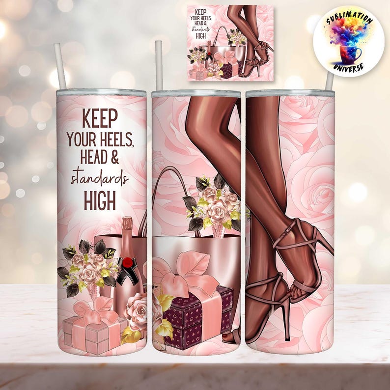 May include: A pink tumbler with a straw, featuring the text "KEEP YOUR HEELS, HEAD & STANDARDS HIGH." The design includes illustrations of high heels, a handbag, gifts, and flowers. The background is a pattern of pink roses.