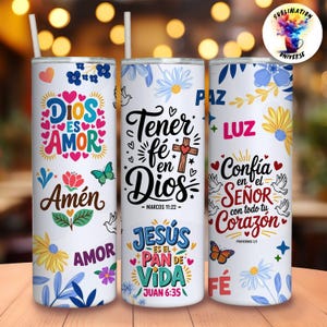 May include: Three white insulated tumblers with floral and religious designs. Each tumbler features text in Spanish, including "Dios es Amor" and "Tener fe en Dios." The tumblers have a straw and are decorated with butterflies and flowers.