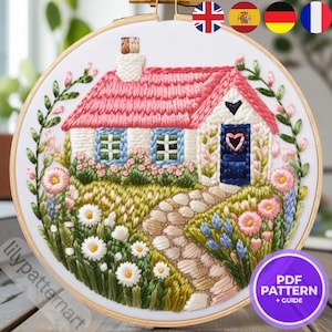 May include: Embroidered hoop art featuring a cottage with a pink roof, blue windows, and a navy blue door with a heart. The scene includes a stone path, flowers, and greenery. The text "PDF PATTERN + GUIDE" is visible.