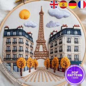 Peut inclure: Broderie sur tambour représentant une scène de rue parisienne avec la Tour Eiffel, des bâtiments, des arbres et des nuages. L'œuvre utilise des nuances de marron, beige, bleu et orange. Un soleil jaune est dans le coin supérieur gauche. Le texte "PDF PATTERN + GUIDE" est dans un cercle violet.