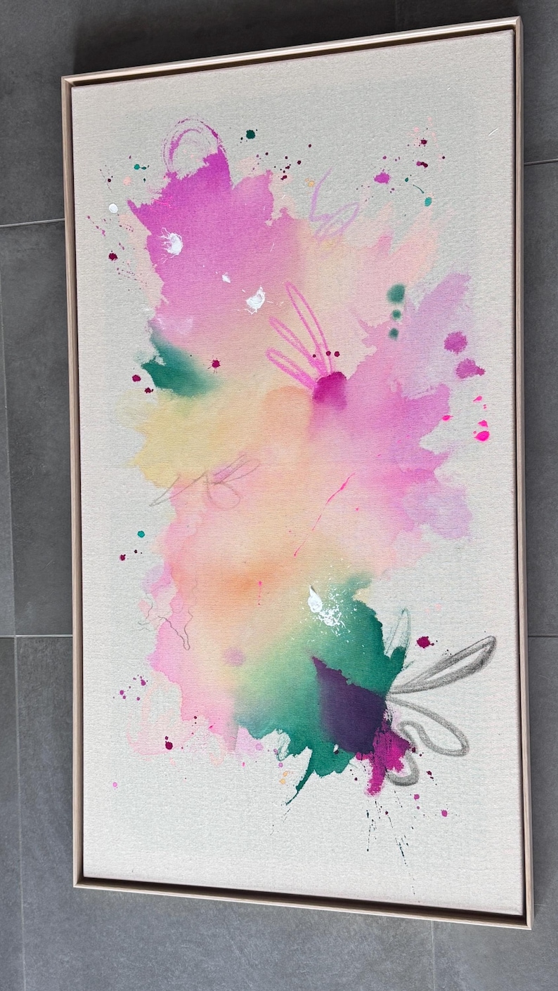 May include: A rectangular framed canvas featuring an abstract painting with vibrant watercolor-style splashes in shades of magenta, yellow, and green. The composition includes delicate hand-drawn line work and scattered paint splatters.