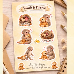 May include: A sheet of stickers featuring adorable monkey illustrations. The stickers include phrases like "Best Friends" and "Nap Time." The monkeys are depicted in various poses, hugging, cuddling, and playing. The stickers have a soft, watercolor style.