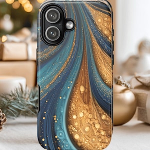 May include: A smartphone case with a swirling abstract design in shades of blue and gold. The case has a glossy finish and features a dual-lens camera cutout. The design incorporates flowing lines and speckled accents, creating a dynamic and artistic look.