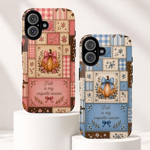 May include: Two phone cases featuring a patchwork design with pumpkins, bows, and floral patterns. One case is pink and the other is blue. Both cases display the text "Fall is my coquette season" with a small bow graphic below the lettering.