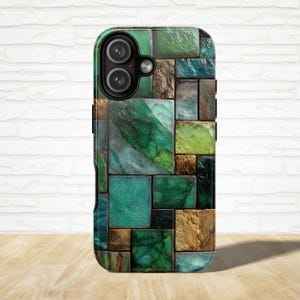 May include: A phone case with a mosaic design featuring various shades of green, teal, and brown. The case has a textured appearance, with the camera lenses visible at the top. The design resembles a collection of irregularly shaped stone tiles.