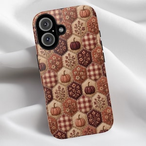 May include: A smartphone case featuring a repeating hexagonal pattern in shades of brown, orange, and cream. The design includes alternating motifs of pumpkins, small floral sprigs, and a classic checkered plaid print across the entire surface.
