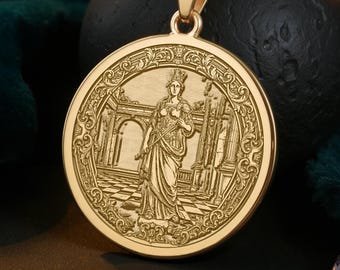 May include: A gold-colored pendant necklace featuring a detailed engraving of a classical figure within a circular frame. The pendant hangs from a delicate chain, set against a dark background with a velvet texture. The design evokes ancient art and mythology.