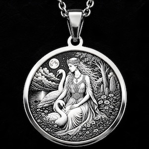 May include: A circular silver-toned pendant necklace featuring an intricate black and white relief engraving of a figure with long hair sitting in a field of flowers with two swans, a full moon, mountains, and trees in the background.