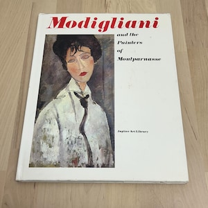 May include: A book titled "Modigliani and the Painters of Montparnasse" with a portrait of a woman on the cover. The book is from the Jupiter Art Library. The cover is white with red text.