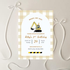 May include: A birthday invitation with a yellow and white gingham pattern. It features a yellow excavator illustration wearing a party hat. Text includes "Ready, Set, Dig!" and details for Riley's 2nd birthday, including the date.