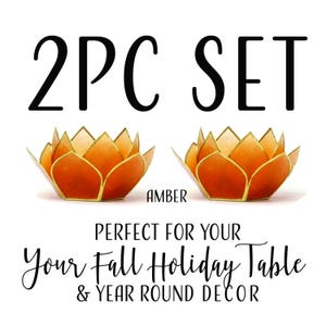 May include: Two amber lotus flower candle holders with gold trim. The text "2PC SET" is above the candle holders. The text "AMBER" is below the candle holders. The text "PERFECT FOR YOUR Your Fall Holiday Table & YEAR ROUND DECOR" is below the candle holders.