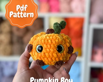 May include: A handmade, plush pumpkin toy in shades of orange, brown, and green. The pumpkin has large, black eyes and is labeled "Pumpkin Boy." The image also includes a tag that says "Pdf Pattern."