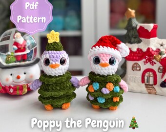 May include: Two crocheted penguin ornaments. One wears a green tree-shaped outfit with a yellow star, the other a red Santa hat and colorful ornaments. The text reads "Poppy the Penguin 2-in-1 Pattern".